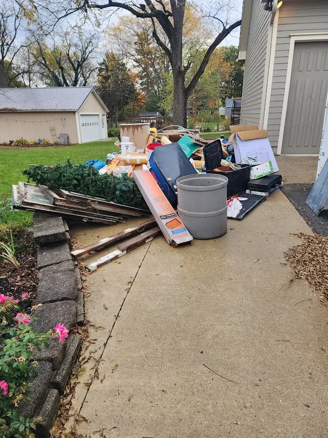 Dumpster being loaded with debris for Roofing Dumpster Rental in Gentry